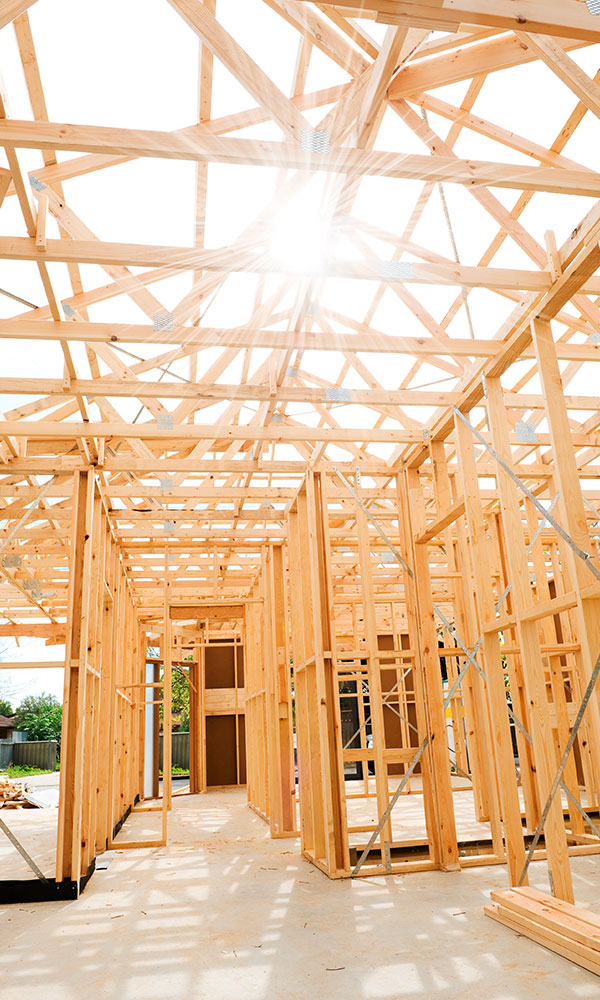 Wood structure ready to build a house with the sun around noon